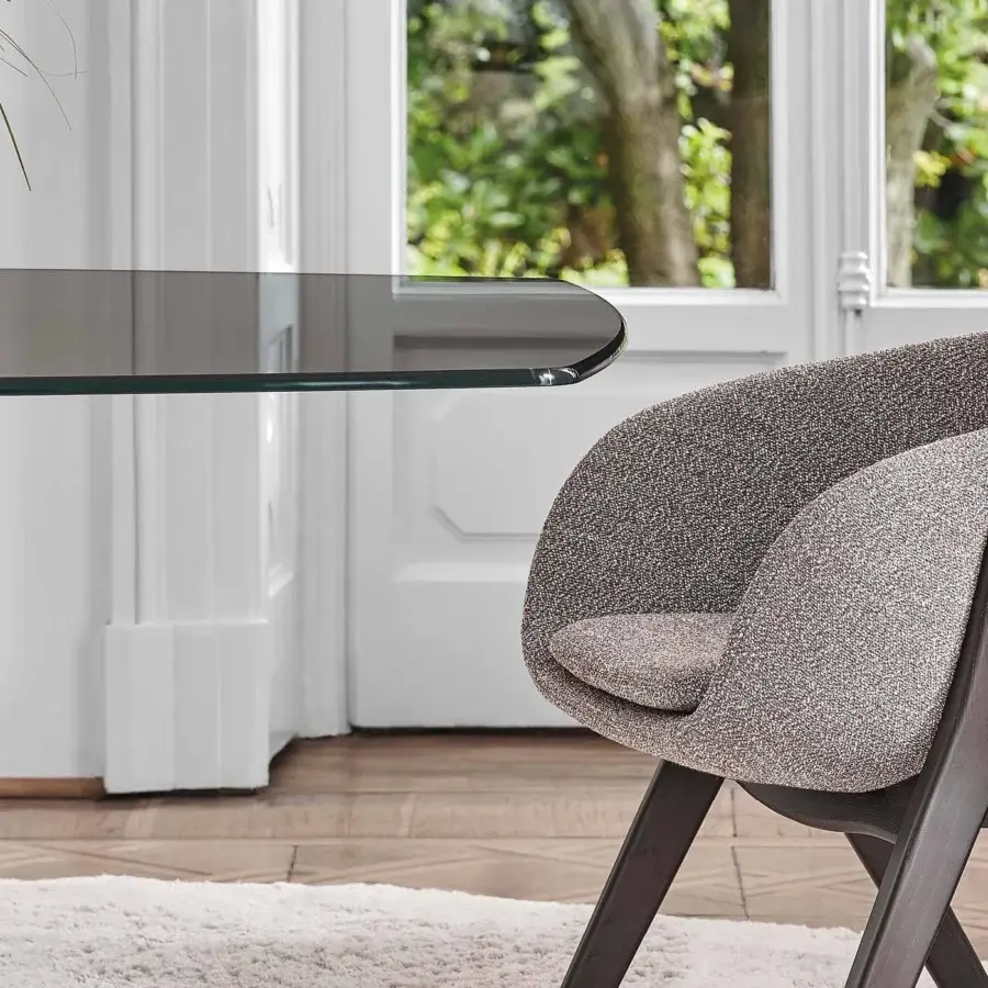 Distinctive Porada Lambda armchair with gently curved form, removable seat cushion, and solid canaletta walnut frame in heathered gray upholstery