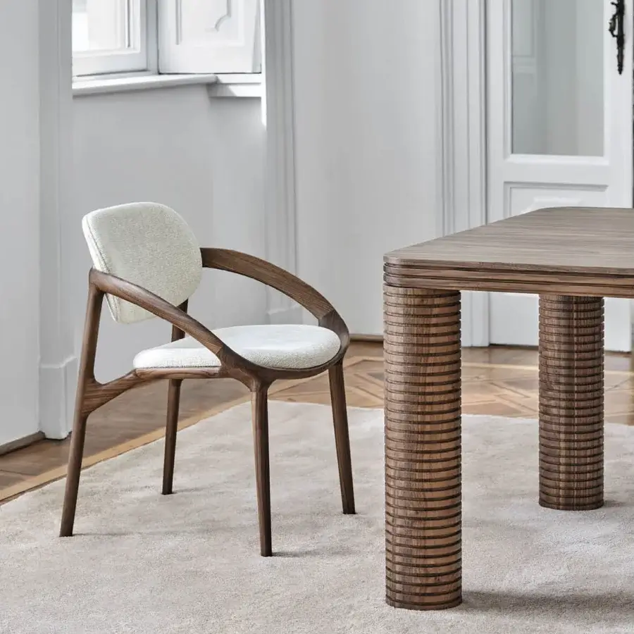 Lavish Porada Molly armchair with a curved canaletto walnut frame and off-white upholstered seat crafted in Italy with a satin finish