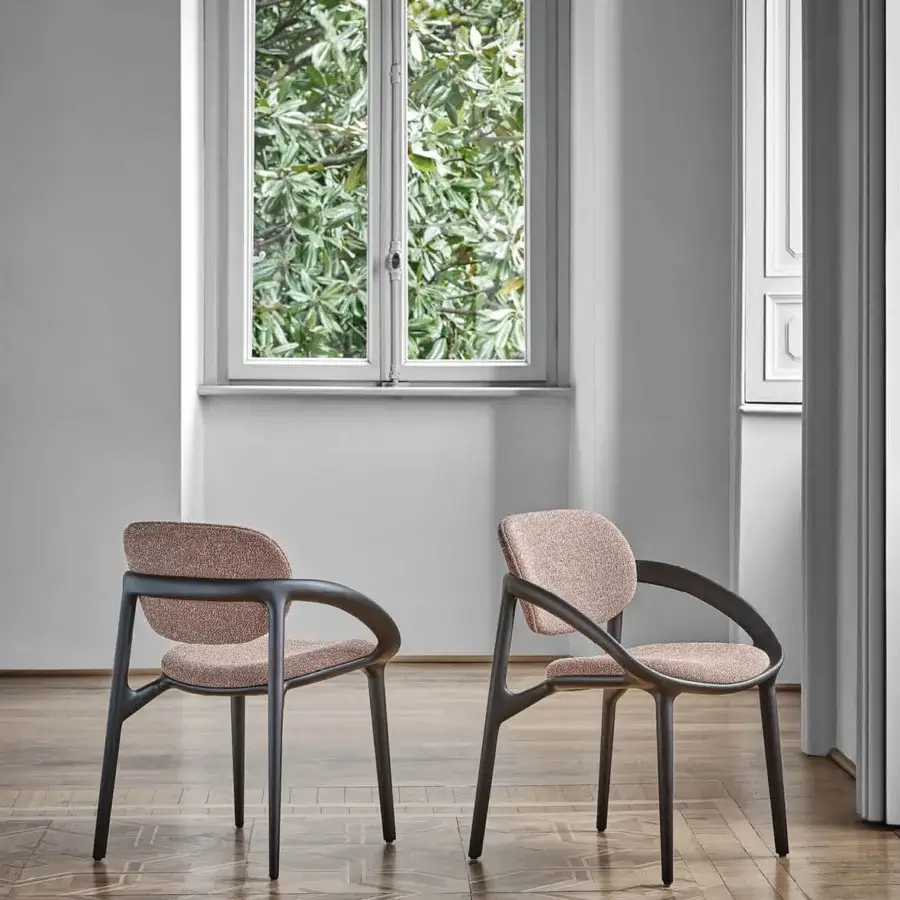 Innovative Porada Molly armchair with a continuous canaletto walnut frame and muted rose textile upholstery with satin finish