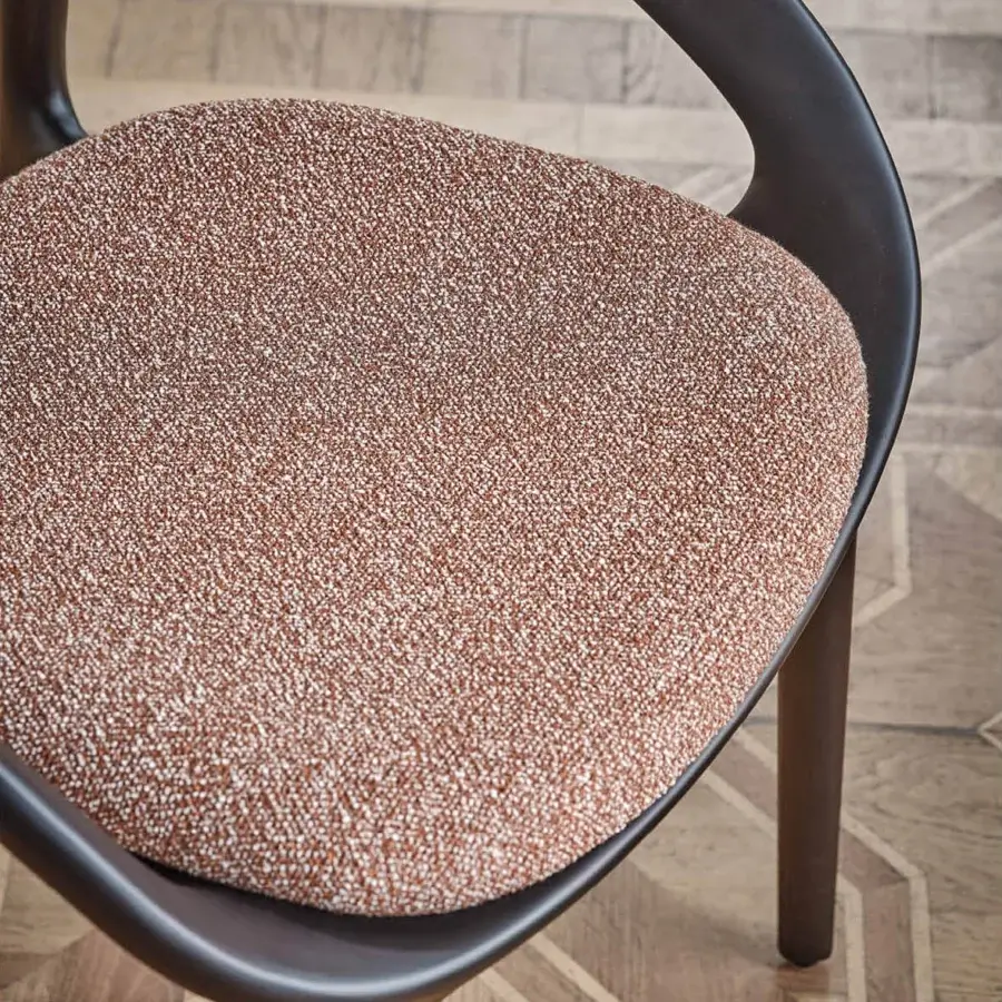 Superior Porada Molly armchair with a continuous canaletto walnut frame and subtly speckled terracotta upholstery