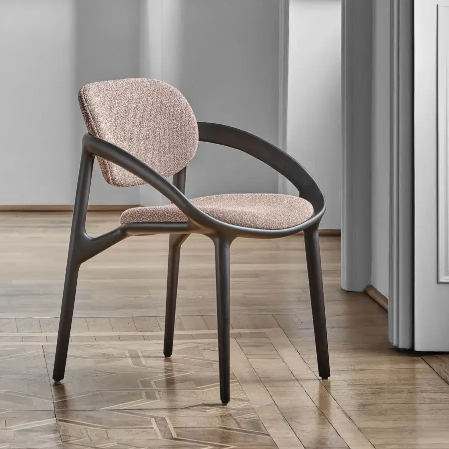 Distinguished Porada Molly armchair with a continuous canaletto walnut frame and neutral textured textile upholstery with matte finish
