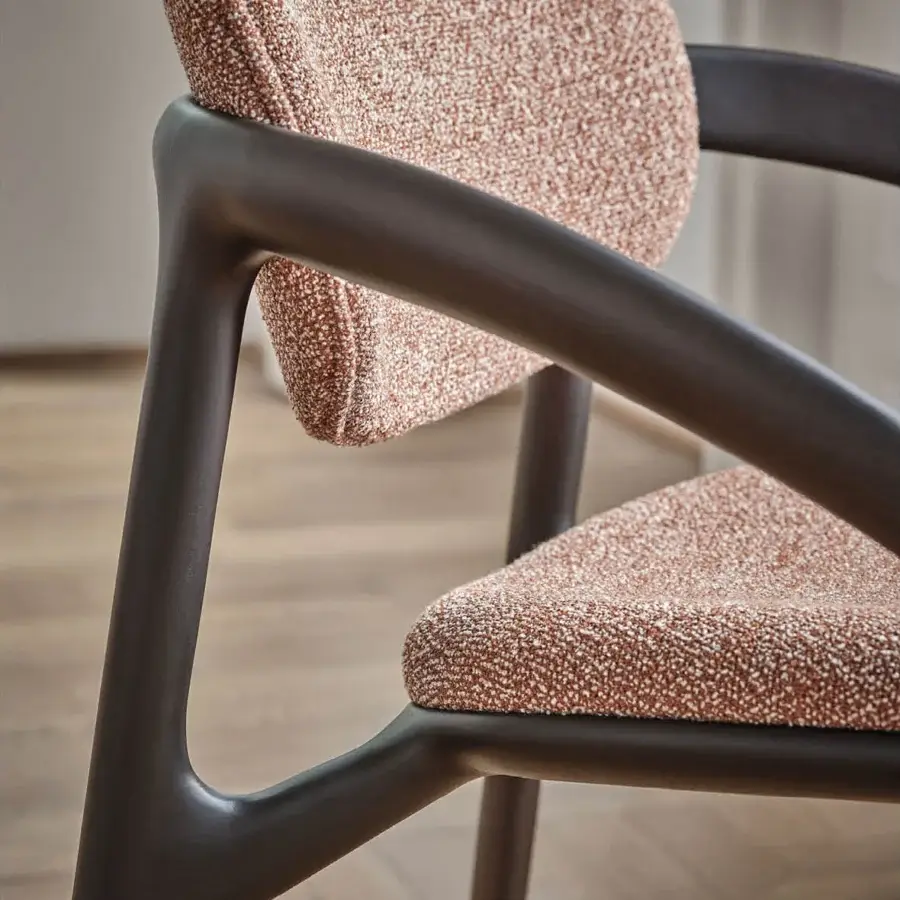 Elegant Porada Molly armchair with a continuous canaletto walnut frame and muted coral textile upholstery with a matte finish