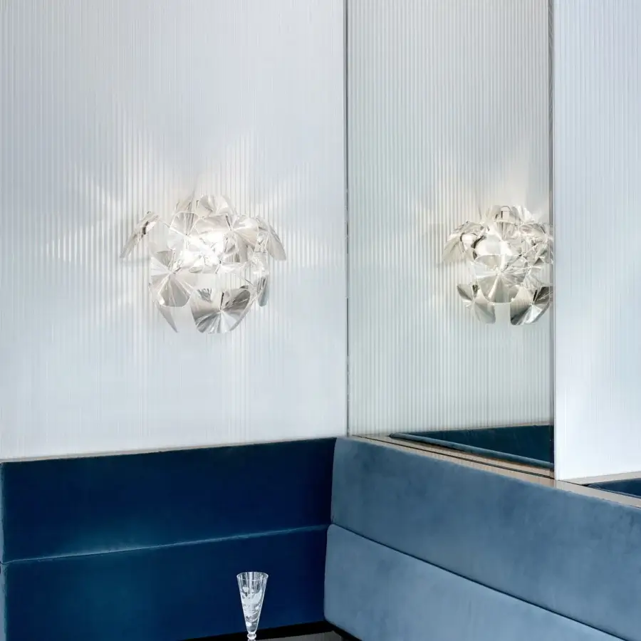 Superior Luceplan Hope Wall Lamp with a polished stainless-steel frame and transparent polycarbonate lenses creating sparkling light diffusion