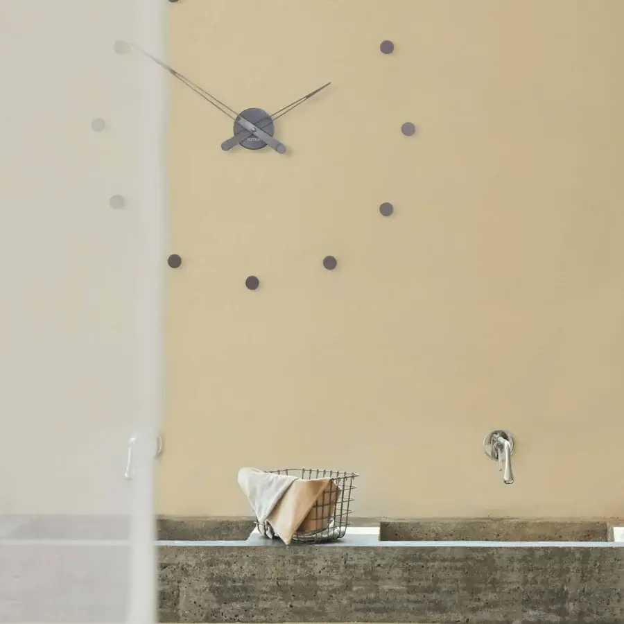 Distinguished Nomon Rodón wall clock crafted in metal with a muted gray matte finish and delicate circular hour markers