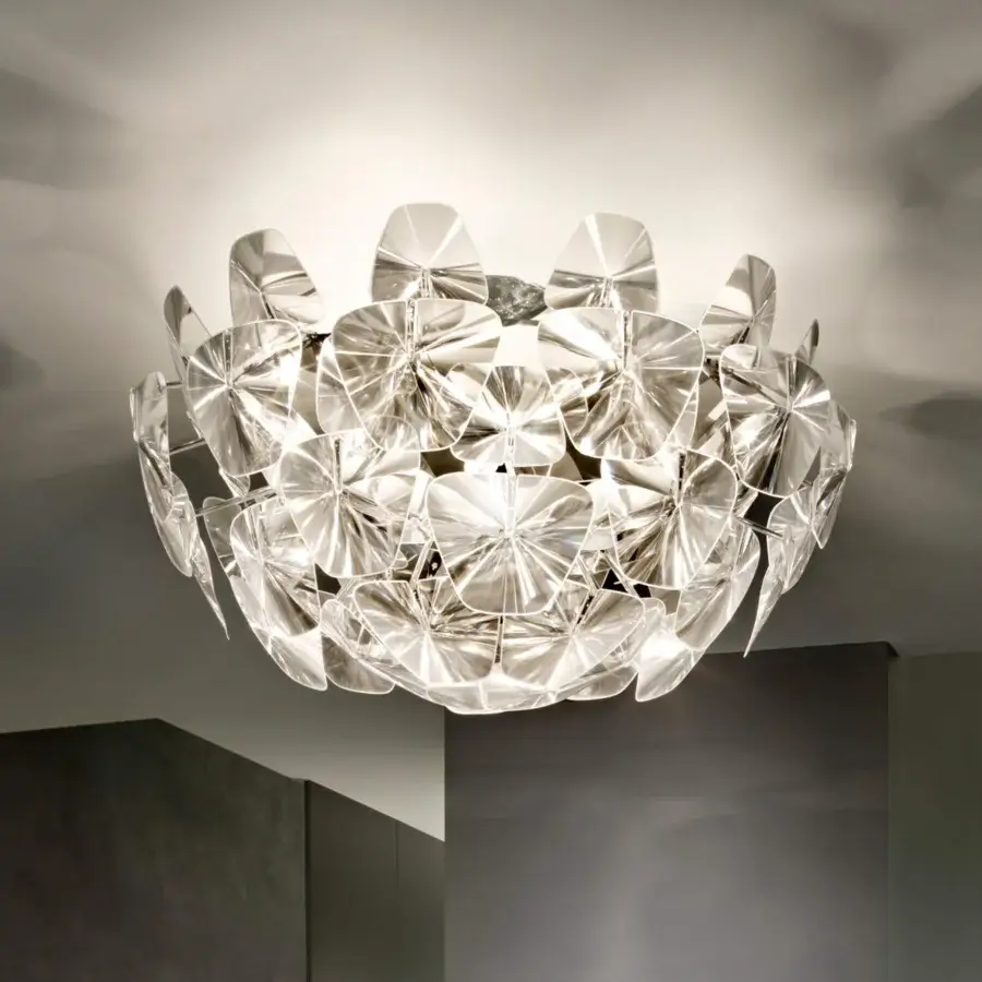 Elegant Luceplan Hope ceiling lamp crafted in transparent polycarbonate with a polished stainless-steel frame exhibiting captivating illumination