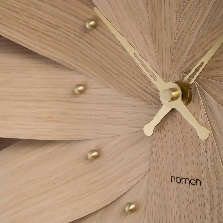 Superior Nomon Brisa Wall Clock crafted in natural oak with a satin finish and polished brass hands