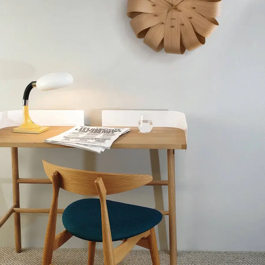 Superior Nomon Brisa Wall Clock crafted in natural oak with a smooth satin finish and radial petal arrangement