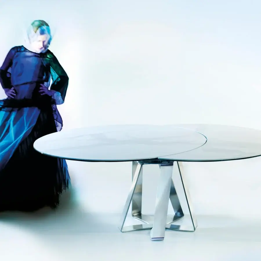 Elegant Naos turning table with white ceramic tabletop and sculptural steel base exhibiting a satin finish