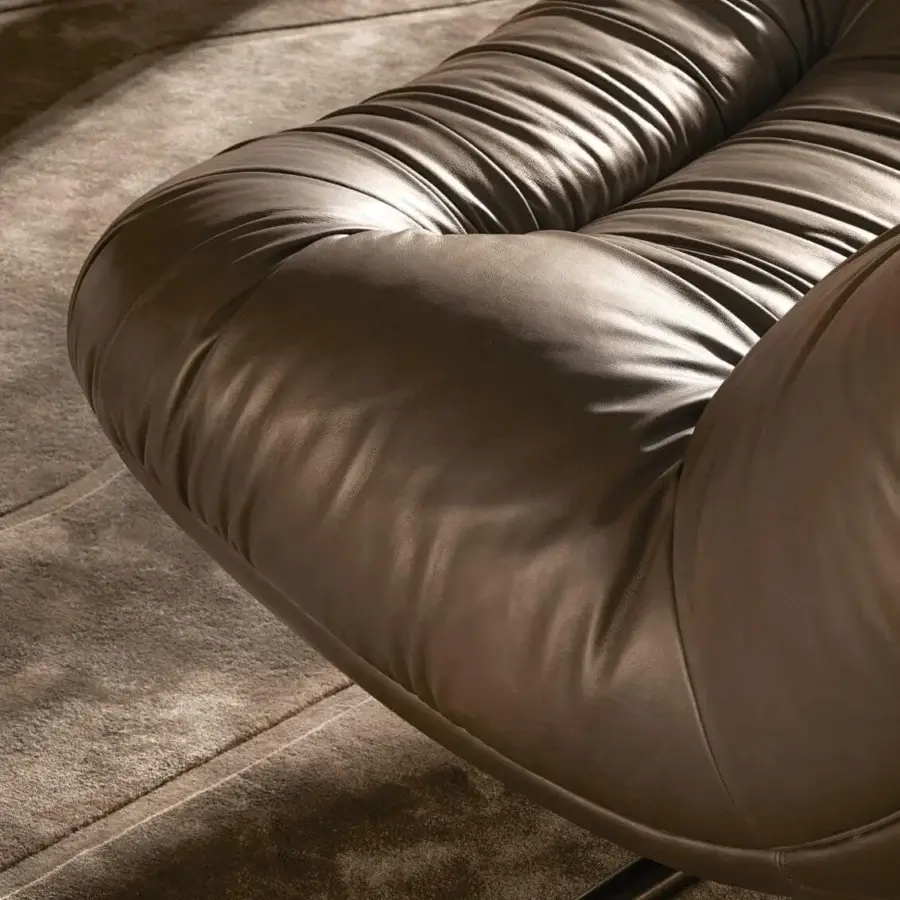 Lavish Visionnaire Aura lounge chair with sculpted wooden shell upholstered in medium-brown leather and satin metal swivel base