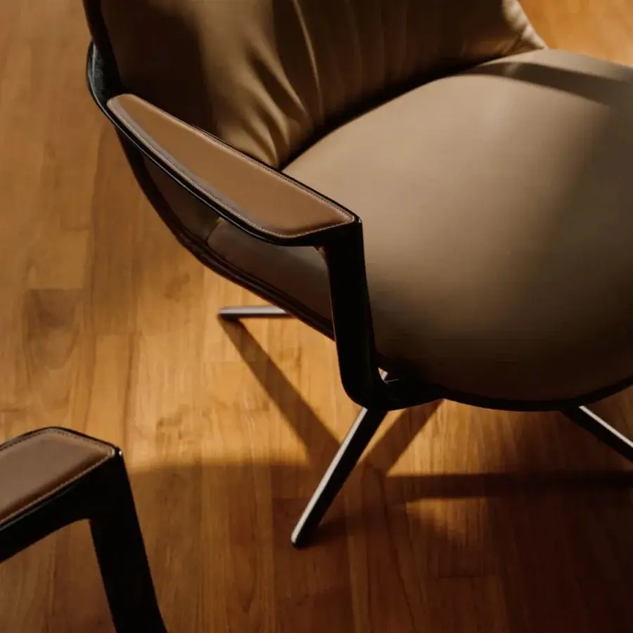 Elegant Visionnaire Spectre lounge chair with enveloping seat, solid ash armrests and polished stainless steel base