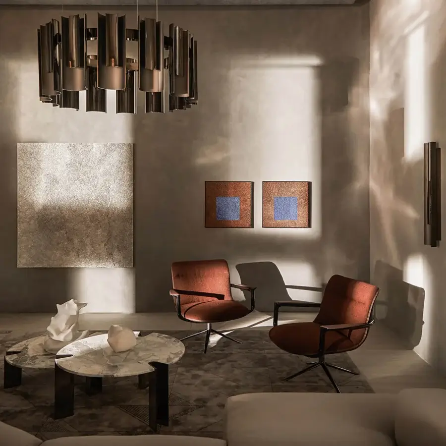 Distinguished Visionnaire Spectre lounge chair with reddish-brown leather upholstery and textured fabric, built with a satin sheen stainless steel base