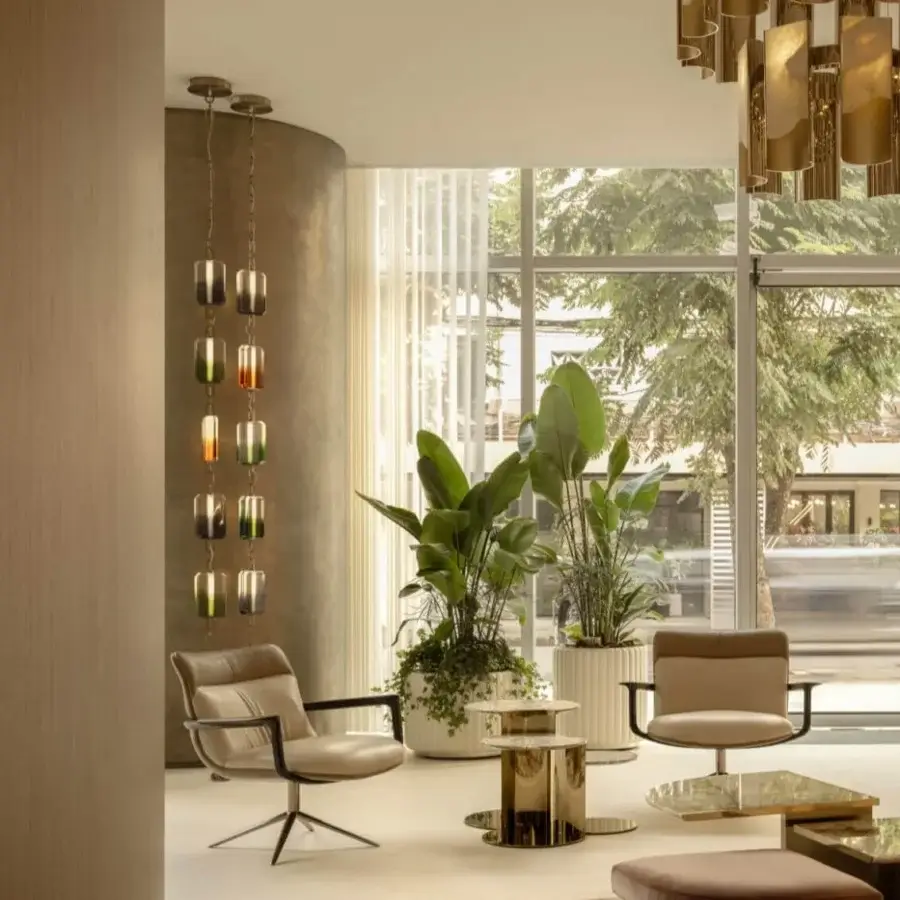 Distinguished Visionnaire Spectre lounge chair with supple beige leather upholstery and high-gloss solid ash armrests built with a polished stainless steel base