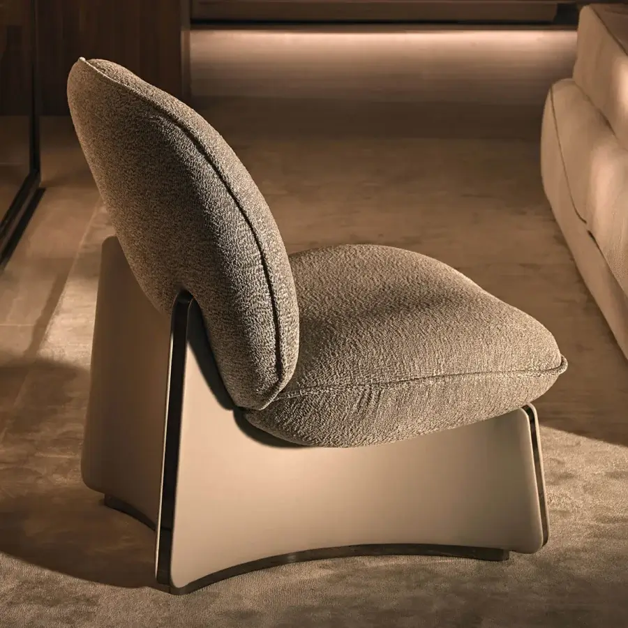 Exceptional Visionnaire Flame lounge chair with enveloping form, muted gray textile upholstery and satin stainless steel edging