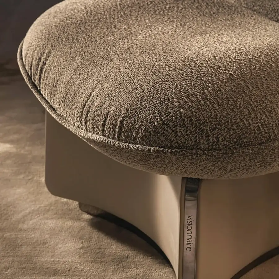 Sophisticated Visionnaire Flame lounge chair with curved wood structure, textured neutral beige fabric upholstery and leather-clad base