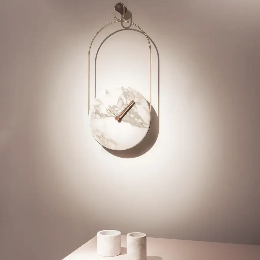 Exceptional Nomon Eslabón Wall Clock crafted with polished marble and gold-toned metal presenting unique veining within a curved frame