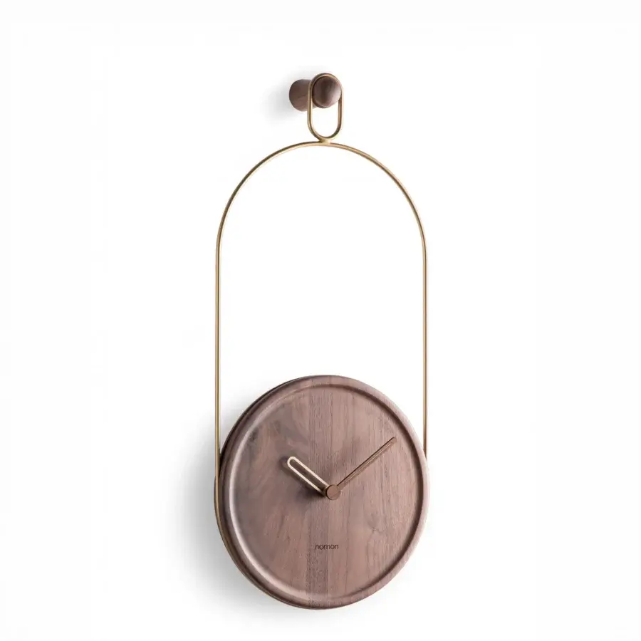 Exceptional Nomon Eslabón Wall Clock crafted in natural walnut with a matte finish and golden-toned metal accents