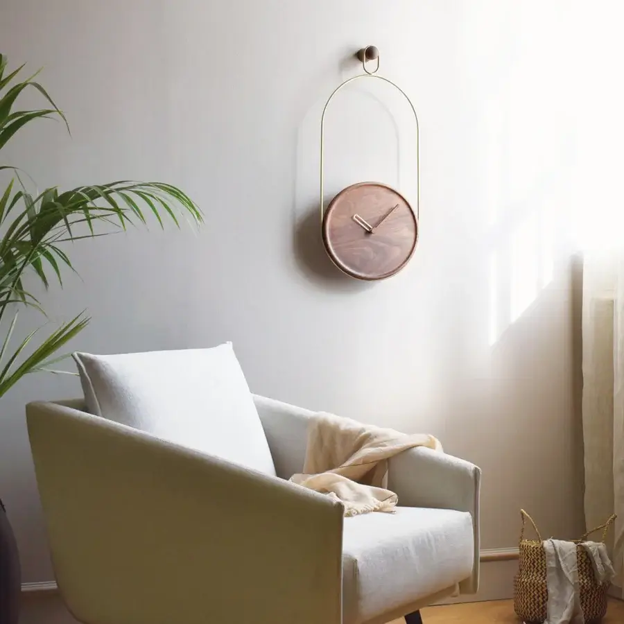 Distinguished Nomon Eslabón Wall Clock with walnut plate suspended from gold-toned metal and satin finish