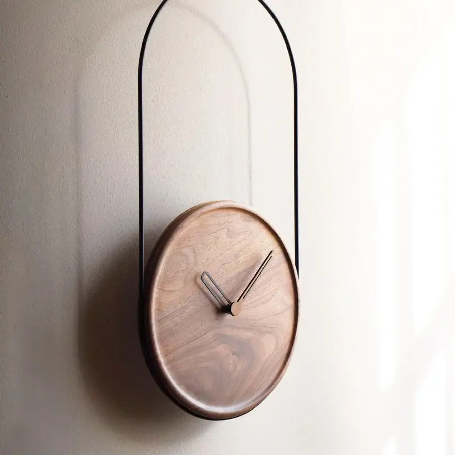 Exceptional Nomon Eslabón Wall Clock with walnut plate suspended in matte black metal and satin finish