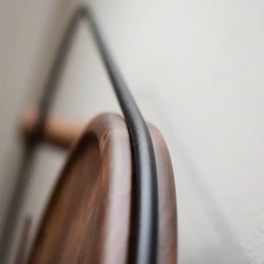 Refined Nomon Eslabón Wall Clock crafted in natural walnut with a satin finish introduces graceful curves and visible wood grain