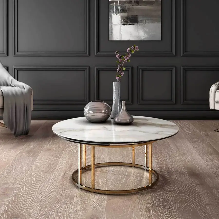 Distinguished Naos Colombo coffee table with a round ceramic top and golden-toned galvanized steel base, exhibiting a subtly glossy finish