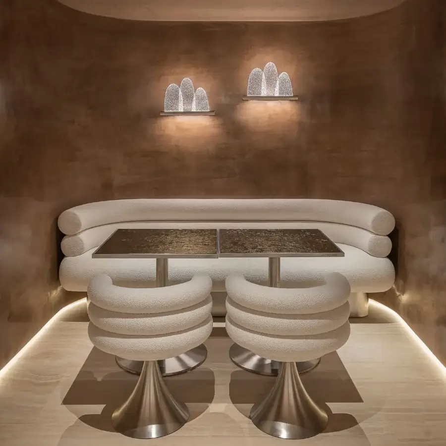 Lavish Visionnaire Voluptas armchair in creamy off-white textile with cylindrical bands and polished stainless steel base