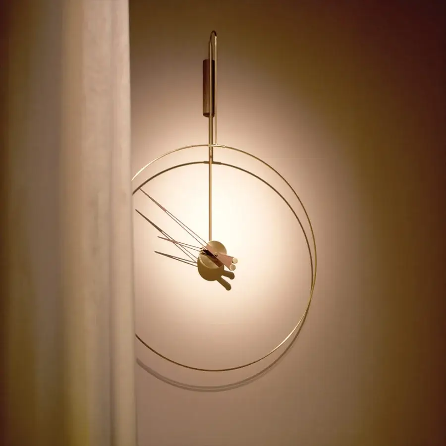 Distinguished Nomon Daro wall clock with gracefully curved metalwork and satin finish creating a light, balanced presence