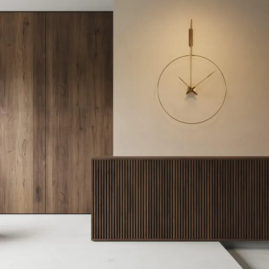 Exceptional Nomon Daro wall clock with curved circular form and warm gold tone satin metal finish