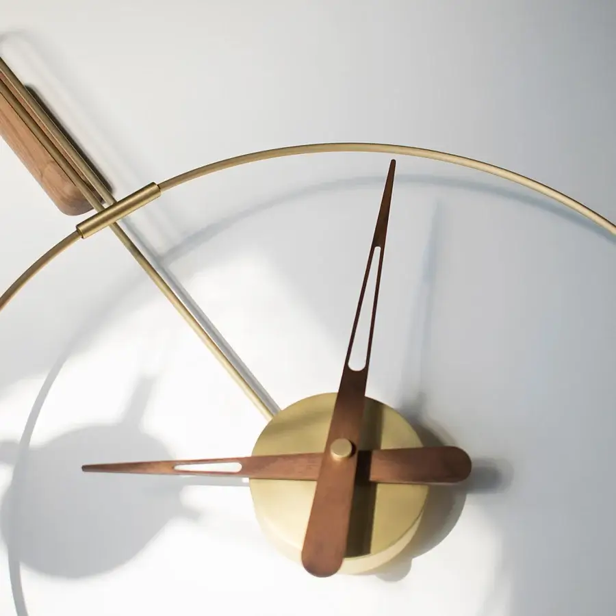 Exceptional Nomon Micro Daro wall clock with contrasting walnut wood hands and polished brass bezel