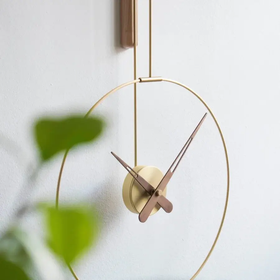 Distinguished Nomon Micro Daro wall clock crafted with polished brass and striking walnut wood hands for a harmonious aesthetic