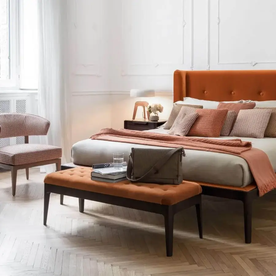 Distinguished Porada Webby ottoman with burnt orange tufted upholstery and solid canaletto walnut frame