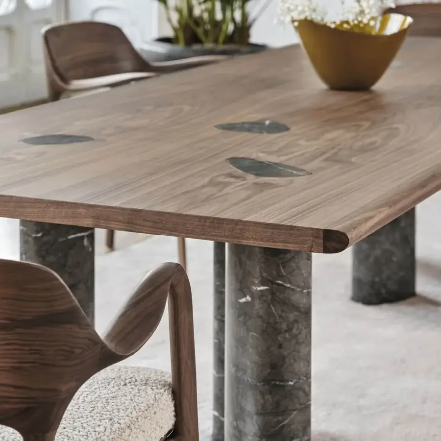 Distinctive Porada Osmose table crafted in canaletto walnut with satin finish and striking marble inserts