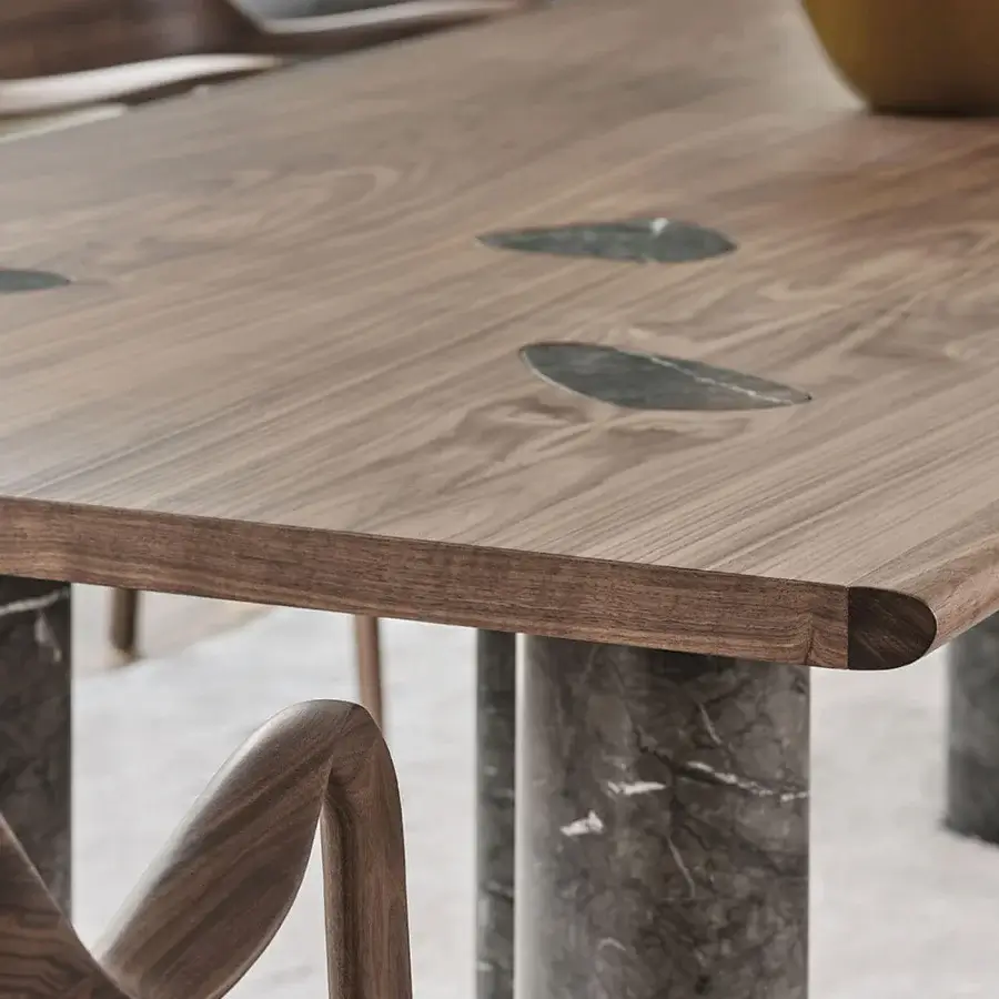 Distinctive Porada Osmose table crafted in canaletto walnut with satin finish and subtle marble inserts in legs