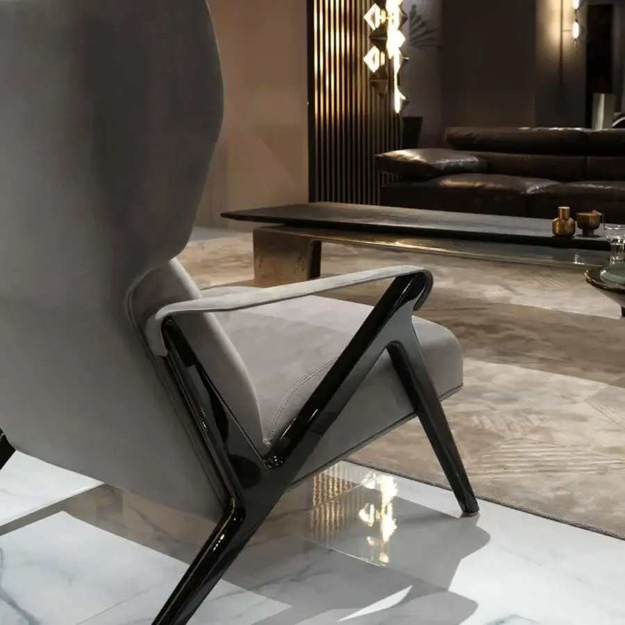 Superior Visionnaire Imagine lounge chair with poplar wood frame, light gray textile upholstery and leather-wrapped metal armrests
