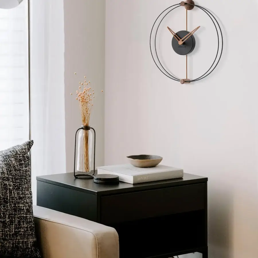 Distinguished Nomon Nano wall clock crafted with black metal and warm walnut wood in a matte finish