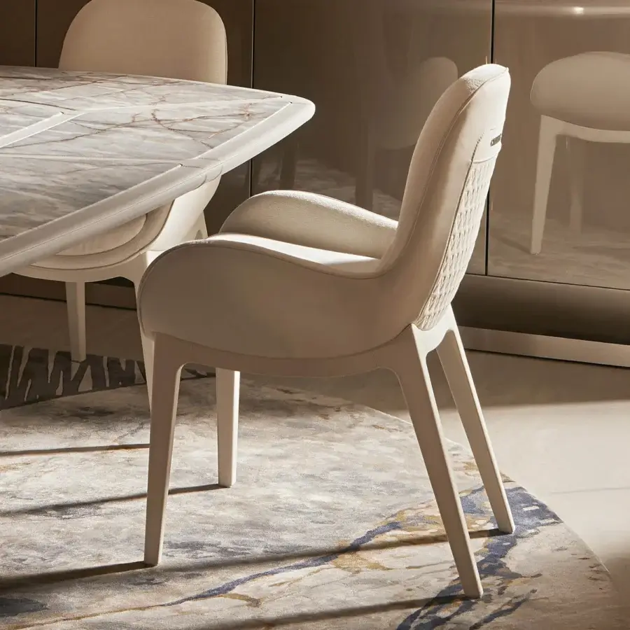Superior Visionnaire Opus armchair with light beige textile upholstery and curved cylindrical bands with patterned stitching