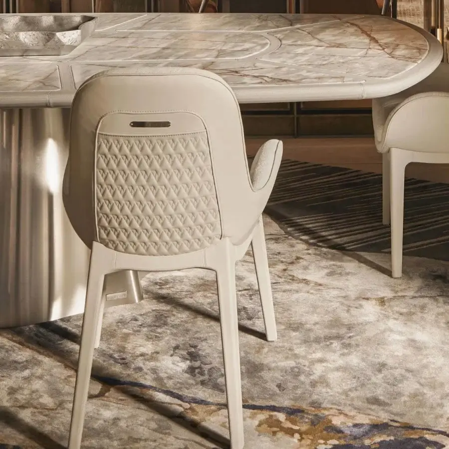 Elegant Visionnaire Opus armchair with quilted light cream textile upholstery and satin-finish stainless steel base