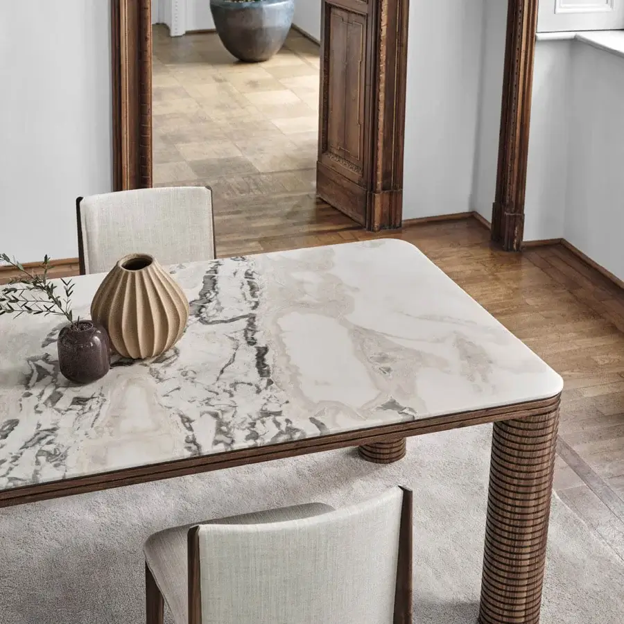 Elegant Porada Sansiro table with a polished white marble top displaying grey veining and a solid canaletto walnut frame crafted in Italy