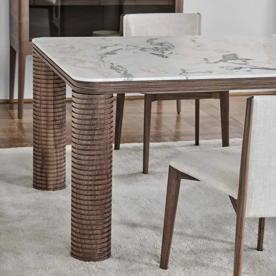 Distinguished Porada Sansiro table with cool marble and warm canaletto walnut crafted in a satin finish