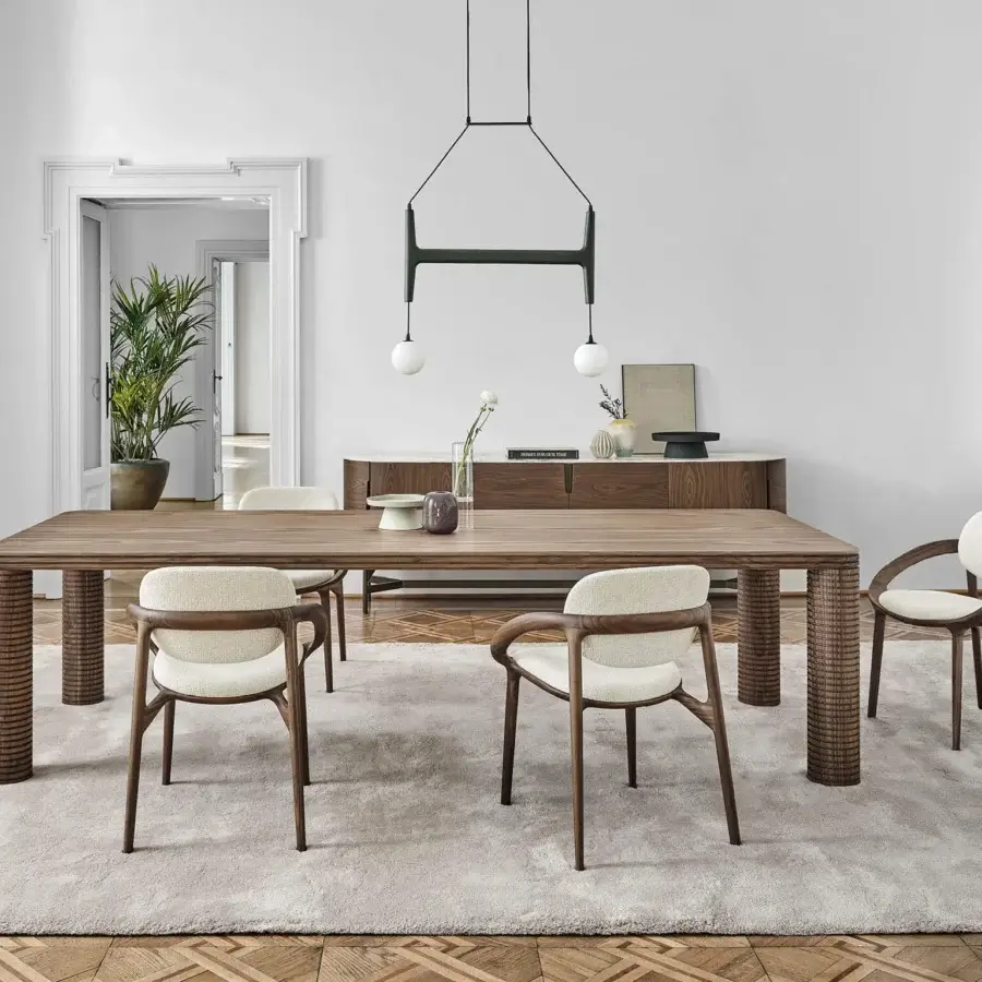 Architectural Porada Sansiro table built with canaletto walnut exhibiting a satin sheen and sculptural turned legs