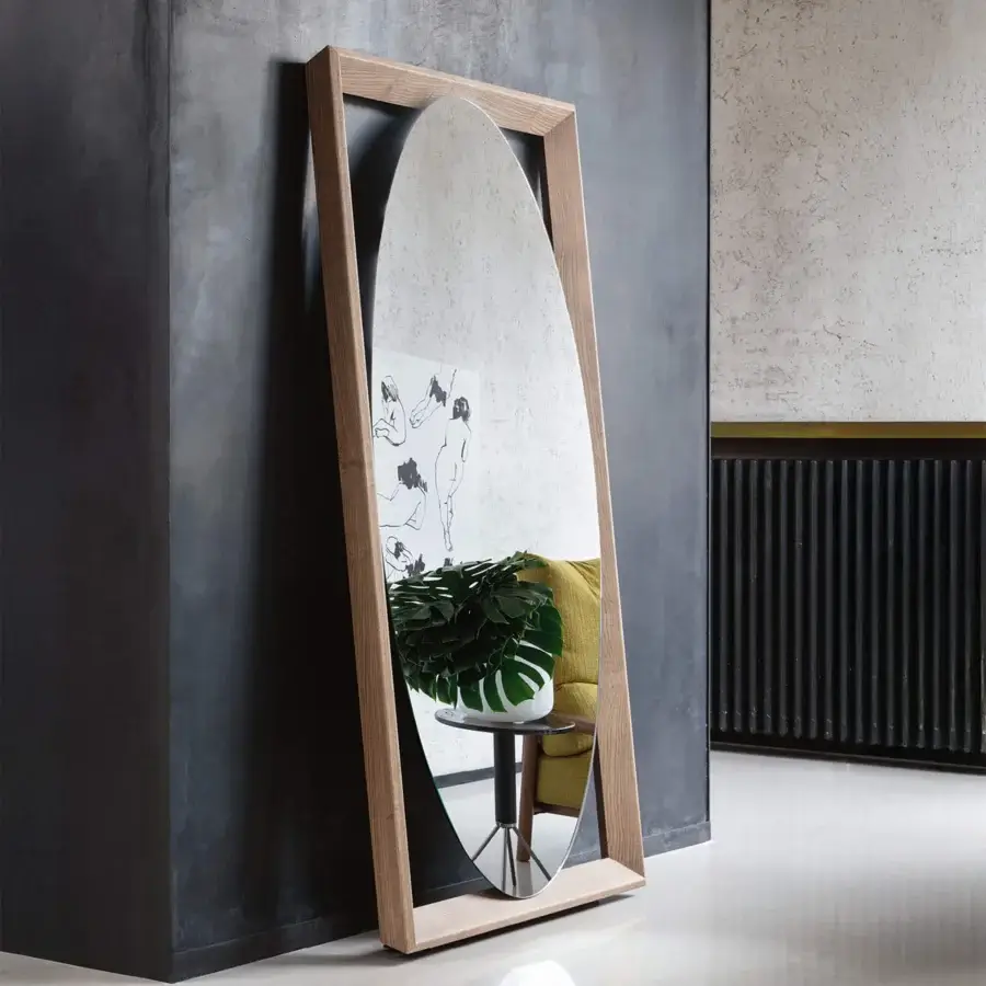 Distinguished Porada Odino mirror with a bold geometric frame and organically curved reflective surface crafted in ash wood with a light to medium tone finish