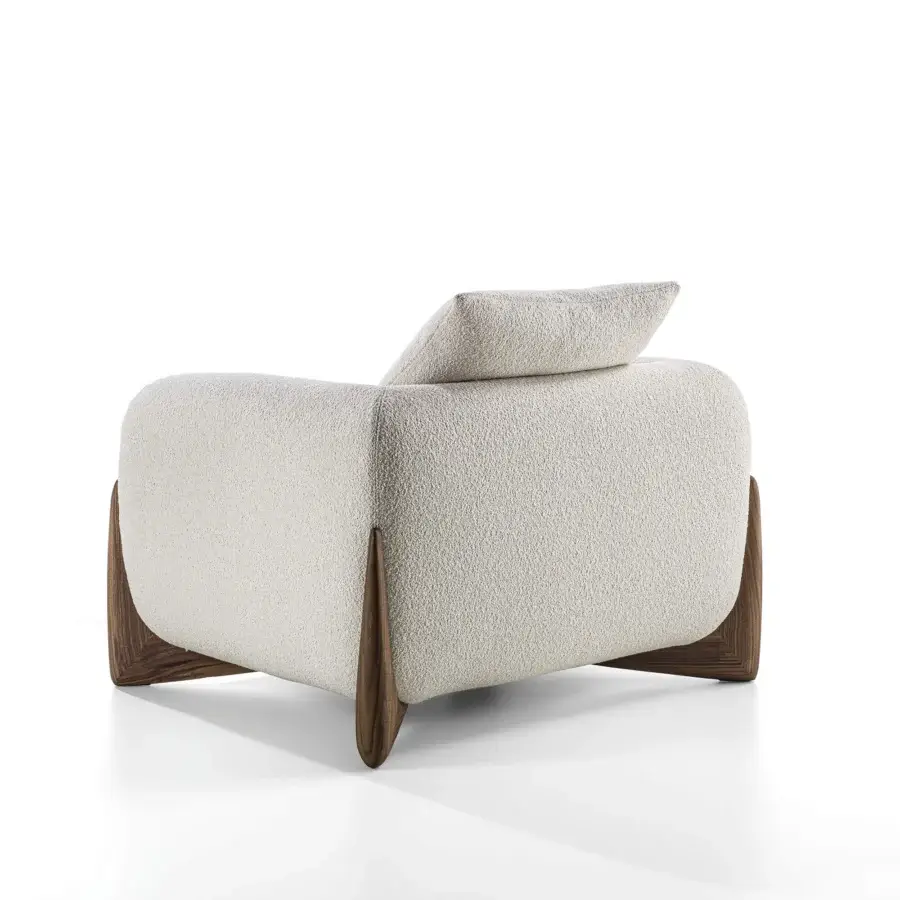 Lavish Porada Softbay armchair with enveloping form and bouclé fabric upholstery in neutral off-white with satin Canaletta walnut base