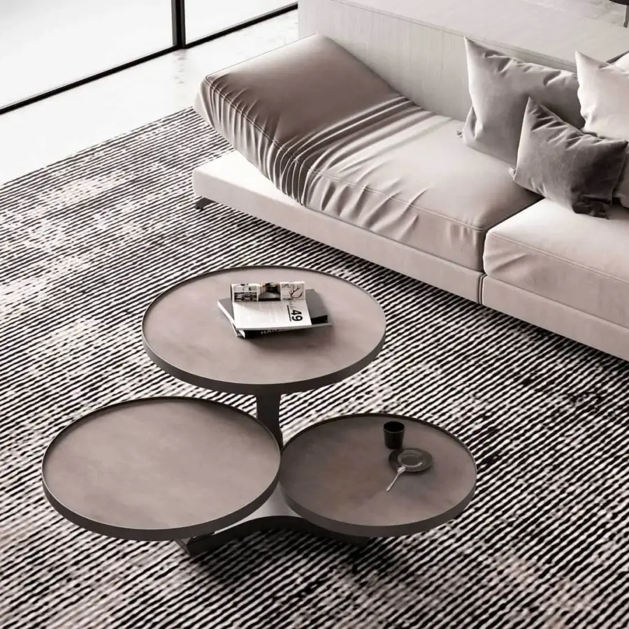 Innovative Naos Extremis coffee table with rotating matte gray ceramic tops and painted steel base