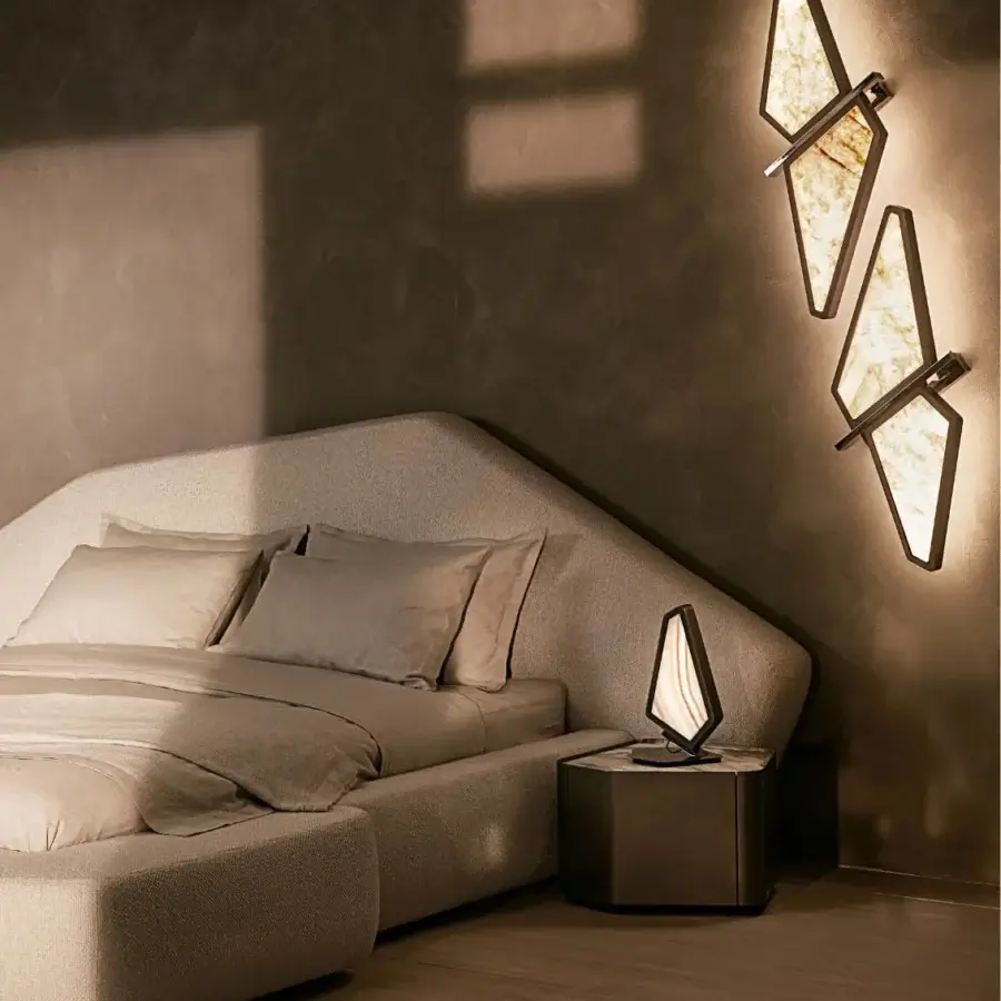 Captivating Visionnaire Astralis wall lamp with shaped metal, striated satin finish and translucent onyx diffusers casting a warm amber glow