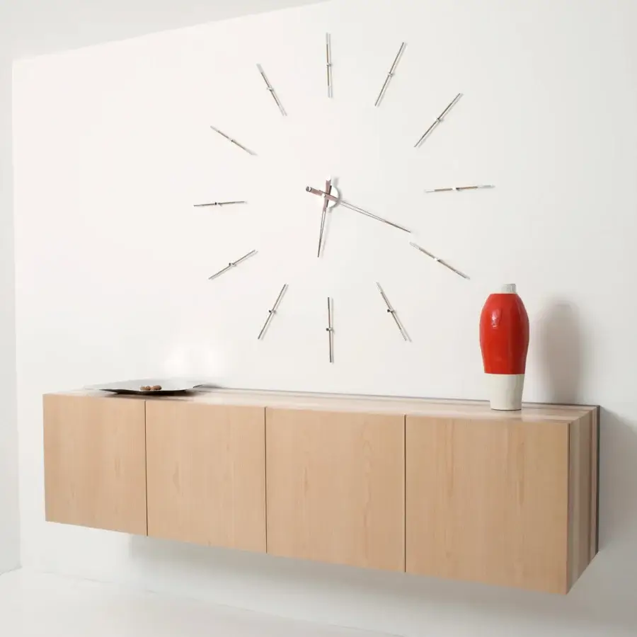 Superior Nomon Merlín wall clock with elongated time markers crafted in wood and metal with a matte silver-grey finish