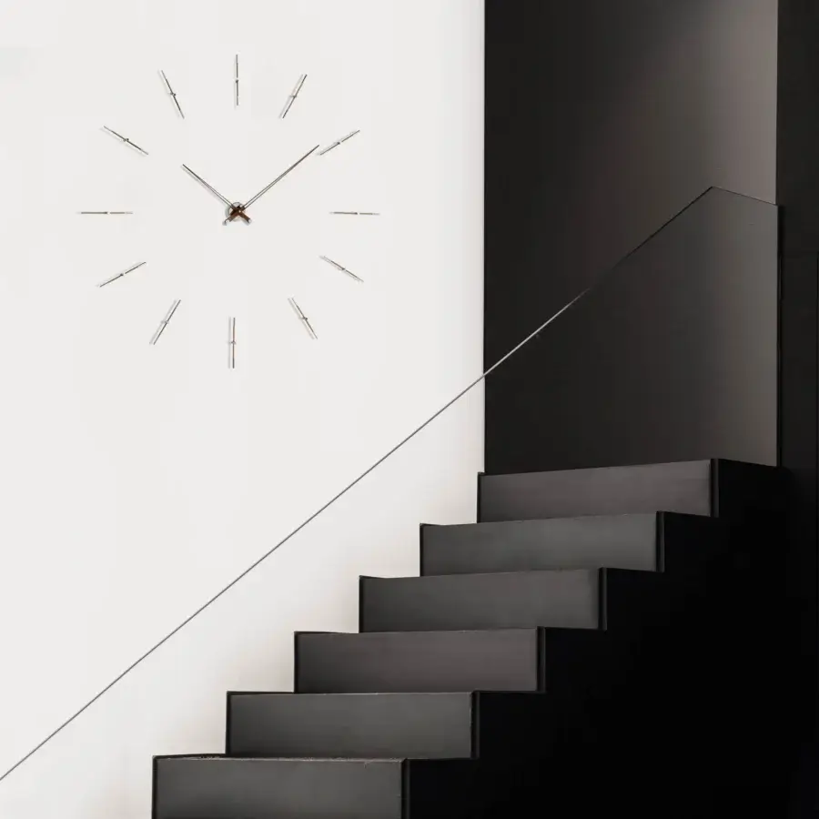 Elegant Nomon Merlín wall clock with twelve unique time markers crafted in wood and metal with matte finish