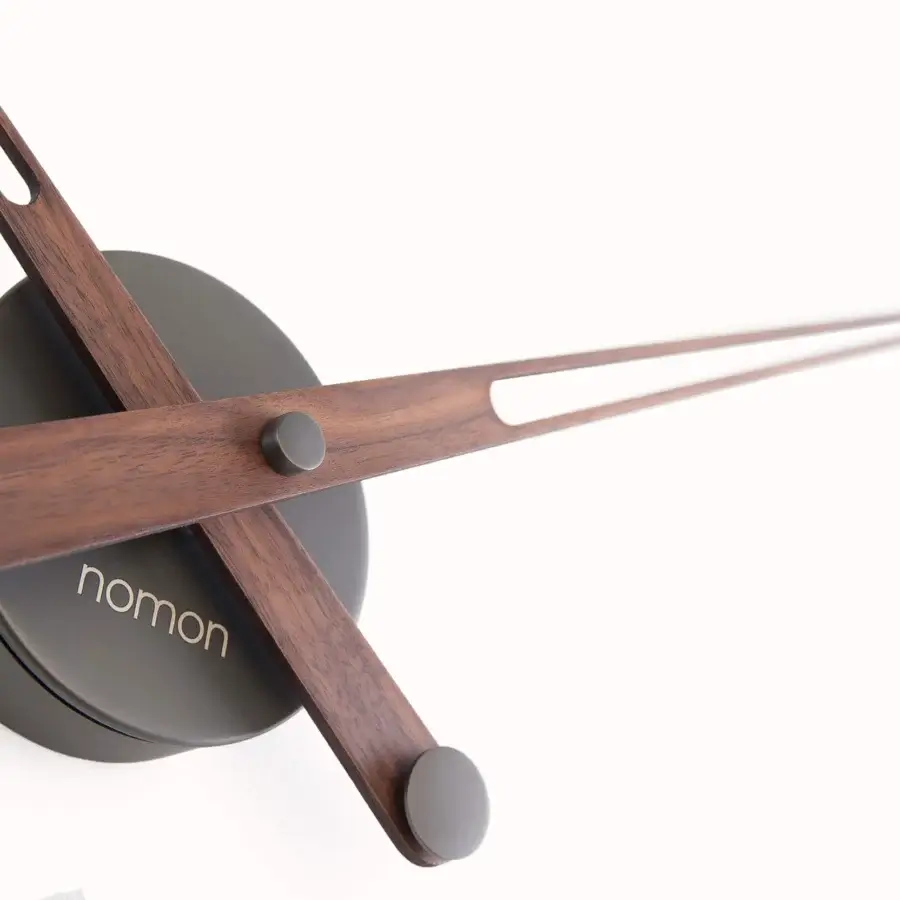 Superior Nomon Merlín wall clock with floating time markers crafted in dark gray metal and warm brown wood exhibiting a satin finish