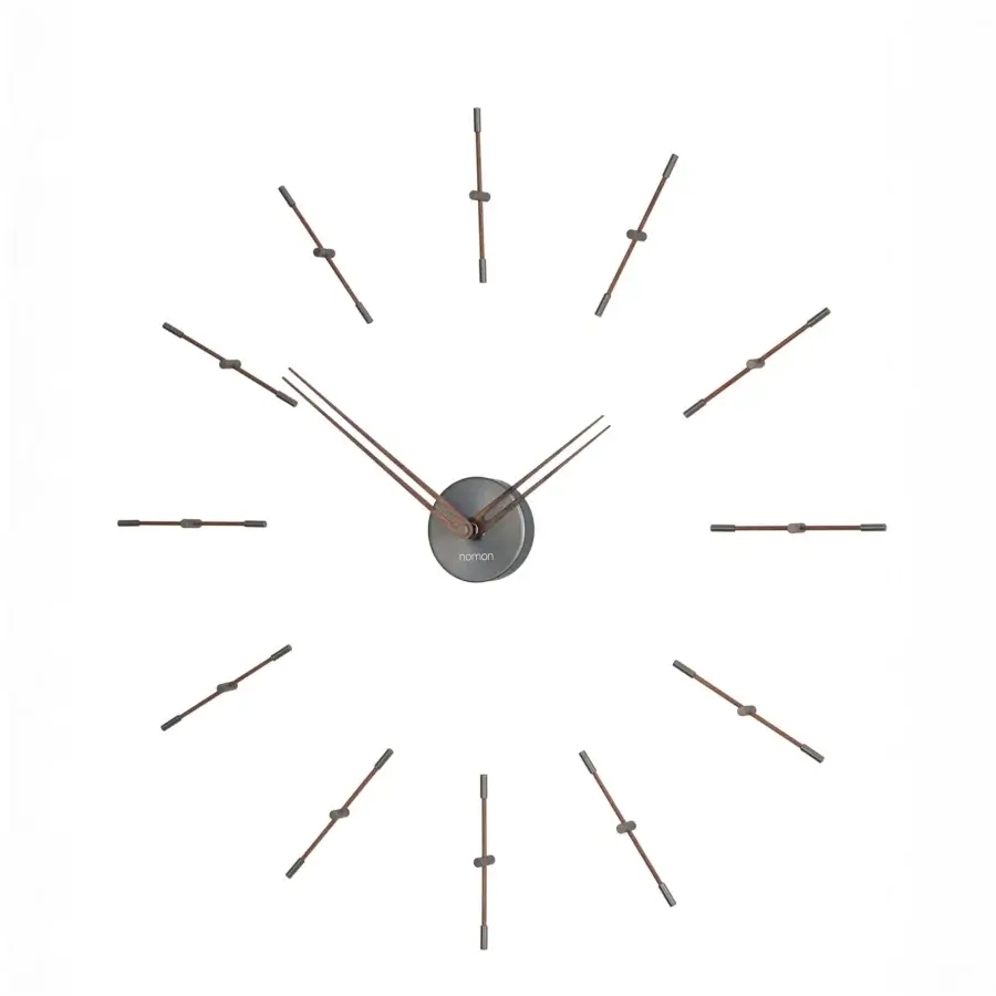 Superior Nomon Mini Merlín wall clock with slender dark bronze metal time signals and a light beige face