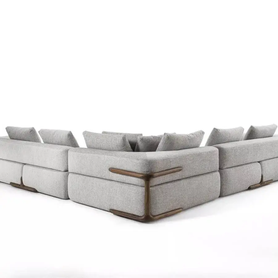 Exceptional Porada Klem sectional crafted with canaletto walnut and light gray textile upholstery, exhibiting distinctive corner supports