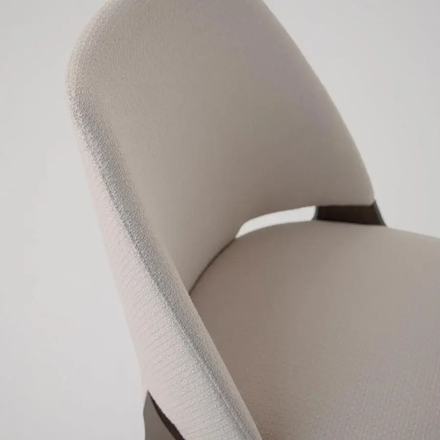 Elegant Potocco Velis Hug chair upholstered in textured neutral beige textile with a smooth satin dark-toned wood frame