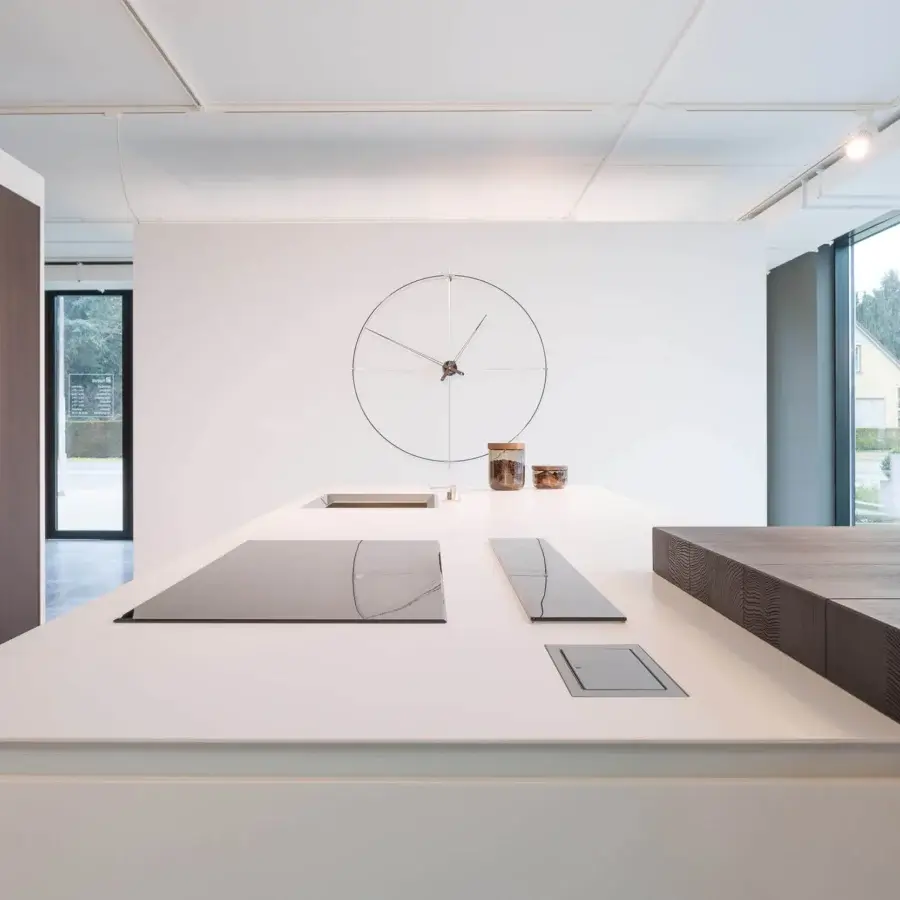 Elegant Nomon Bilbao wall clock with a fiberglass ring and warm walnut hands crafted in a contrasting light face